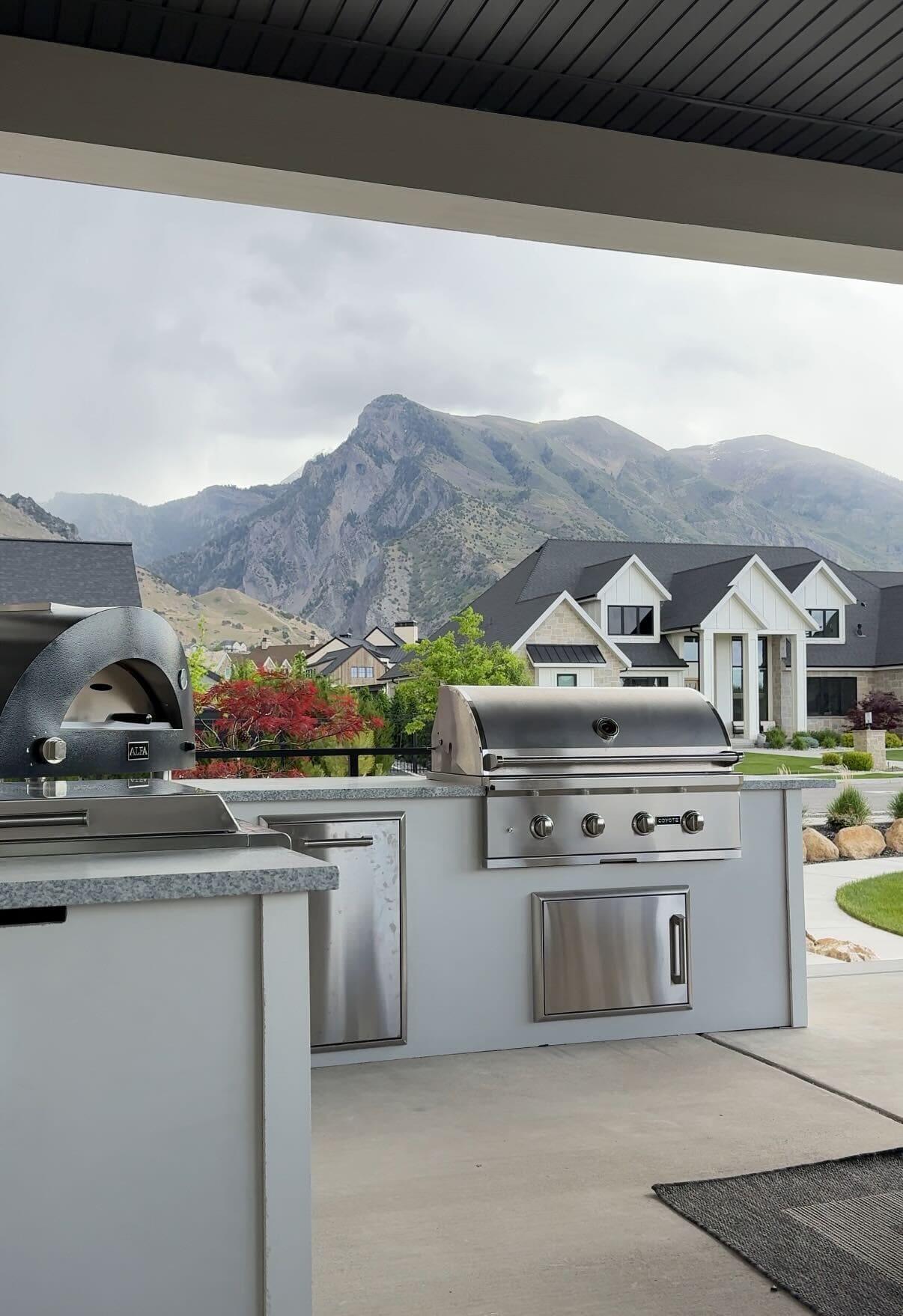 Finished RTA outdoor kitchen in our backyard with Alpha White countertops and Modern Bright Concrete base