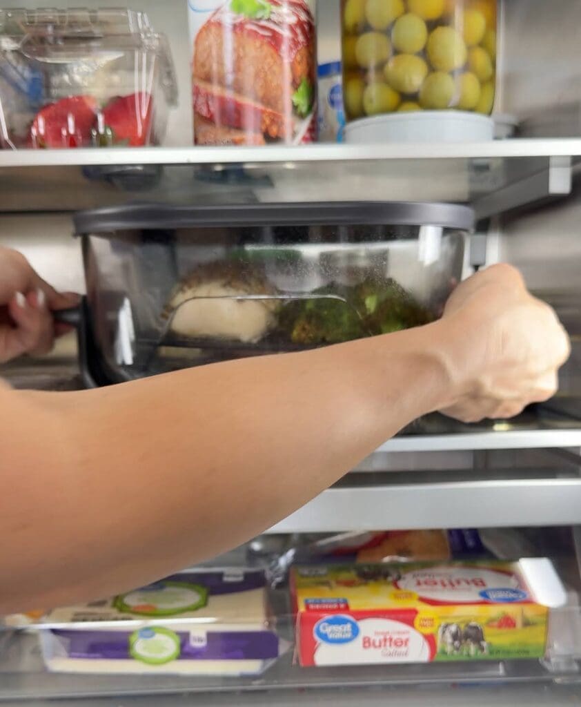 The Ninja air fryer neatly stored inside a refrigerator, showcasing its freezer-safe feature.
