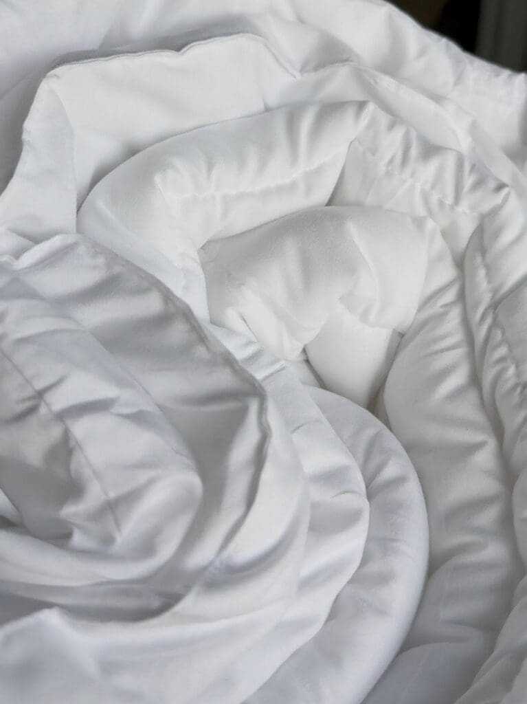 Rolled Amazon duvet insert showcasing lightweight, fluffy fill and soft material texture.