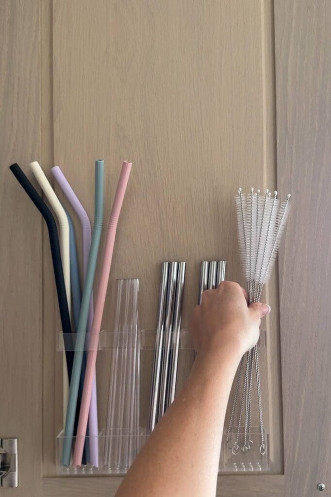 Hand placing straw cleaning brushes into the organizer compartments