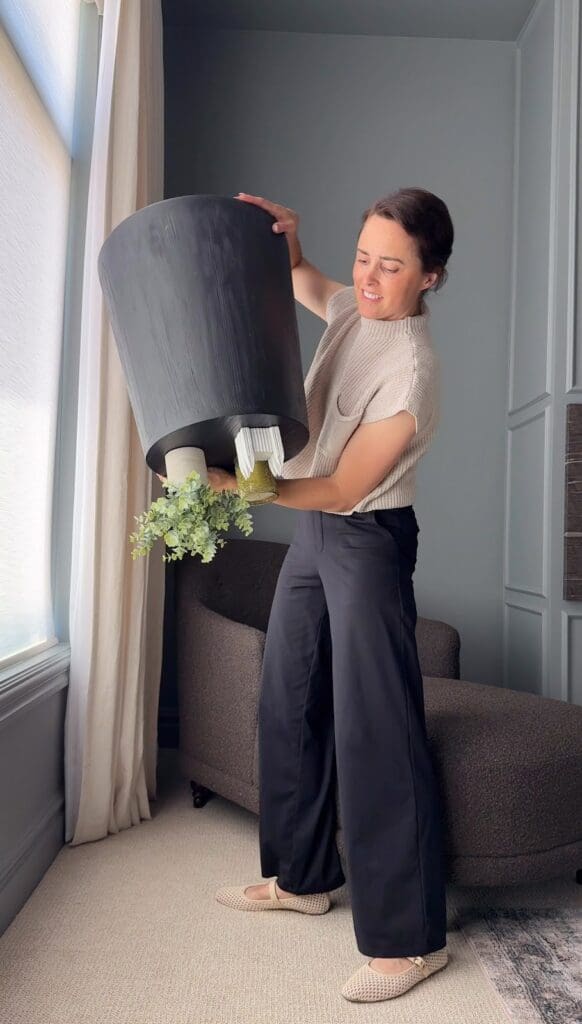 Demonstrating strength of museum gel by holding an upside-down planter with decor intact
