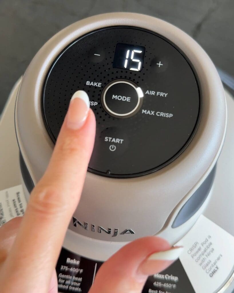 Close-up of digital mode selection on the Ninja air fryer, set to air fry at 15 minutes.