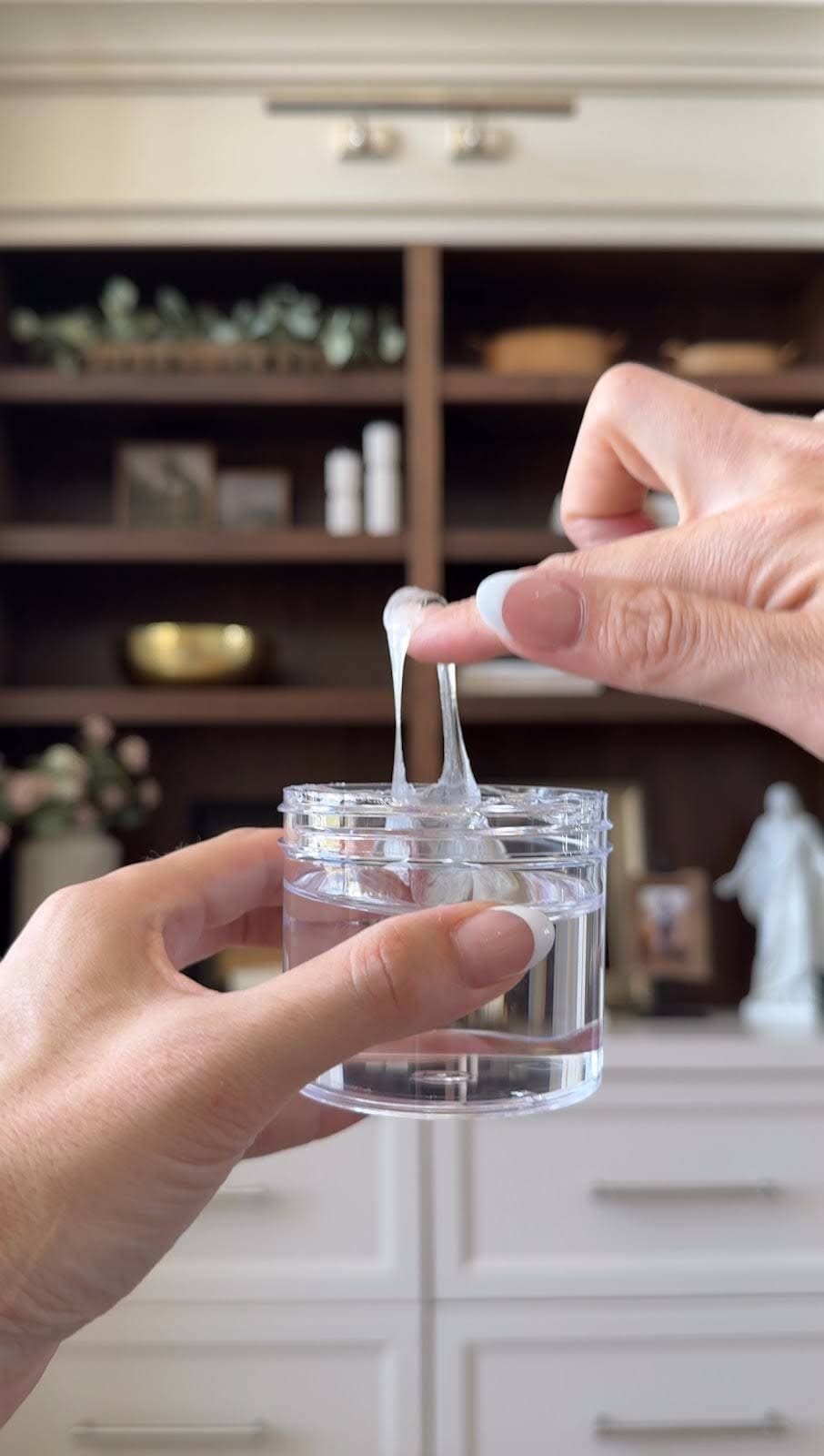 Stretching clear museum gel from jar
