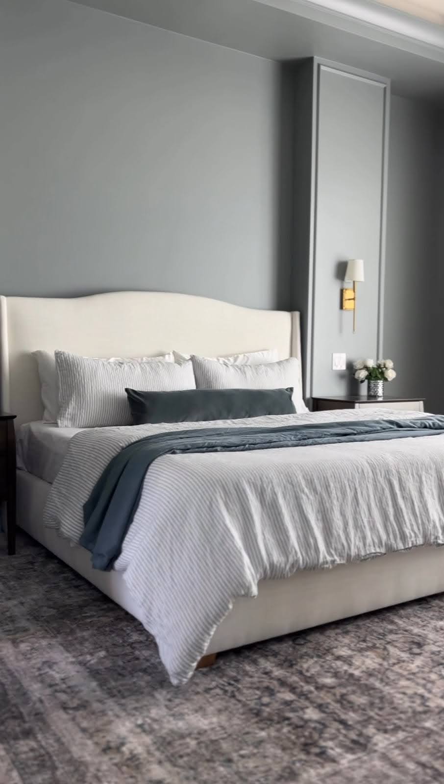 Neutral primary bedroom styled with upholstered bed, layered bedding, and Amazon duvet insert.