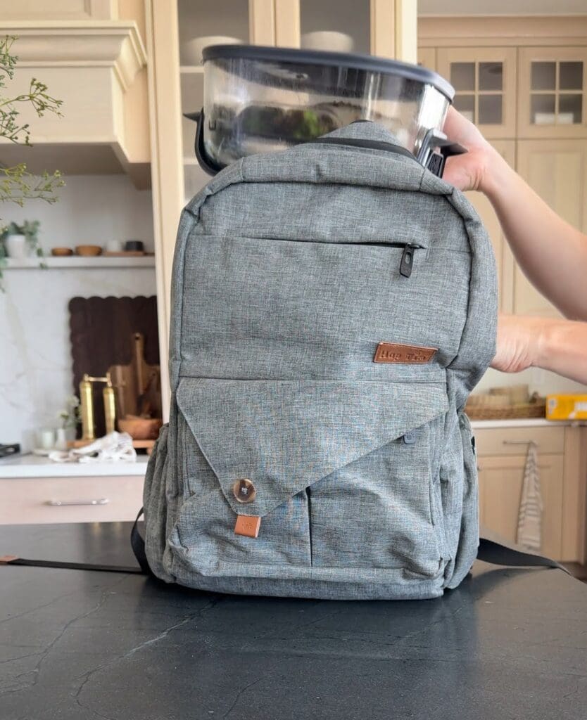 Portable Ninja air fryer being stored neatly in a gray backpack, showcasing its portability.