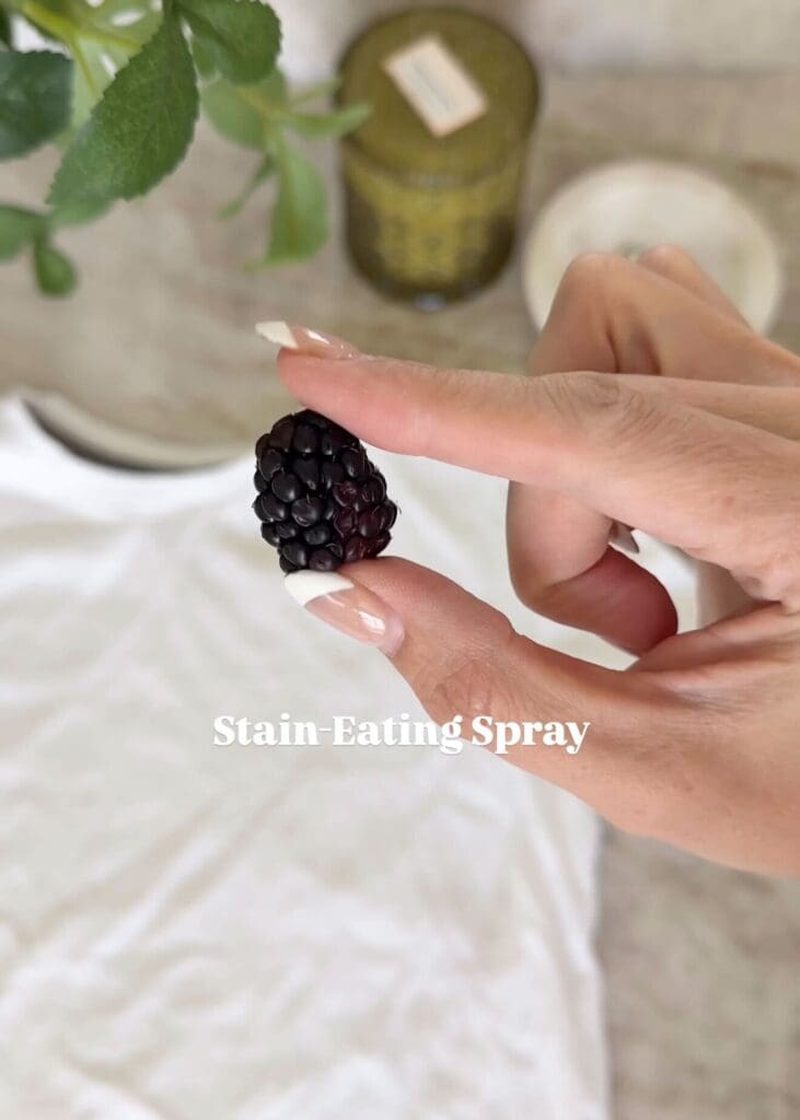 Close-up of Andrea  holding a blackberry over a white shirt