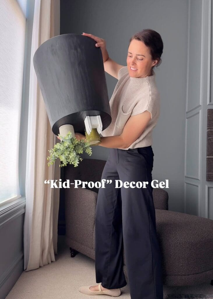 Andrea holding up a large planter, showing gel securing it to the base