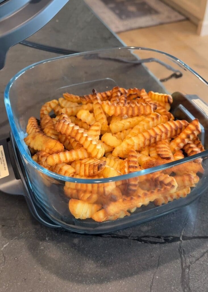 Crispy crinkle-cut fries inside the Ninja CRISPi glass basket