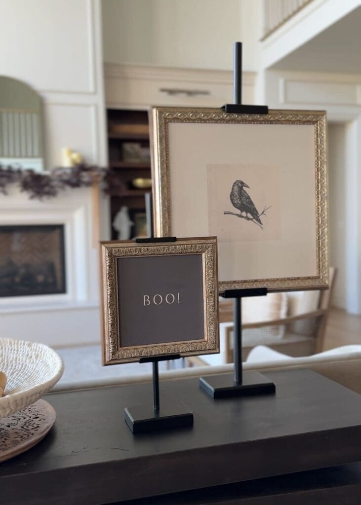 Side view of framed artwork styled on adjustable easels on a console table