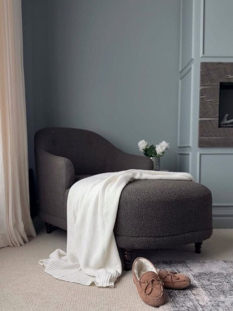Real lounge chair scene with slippers and throw.