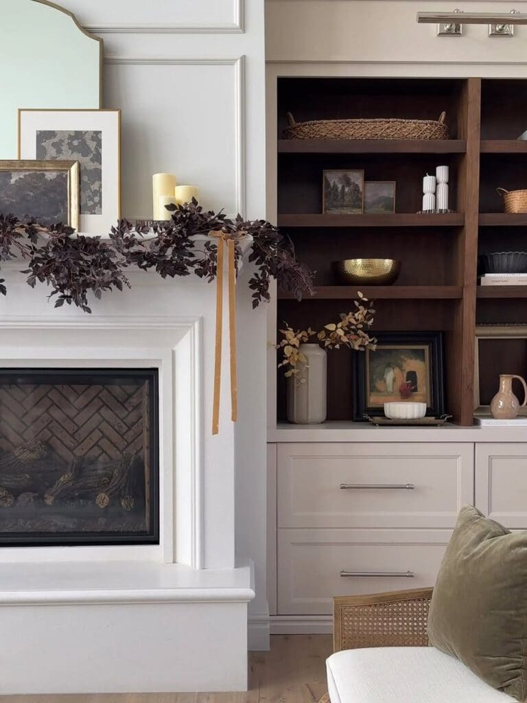 Real living room built-ins and mantle styled with art and garland.