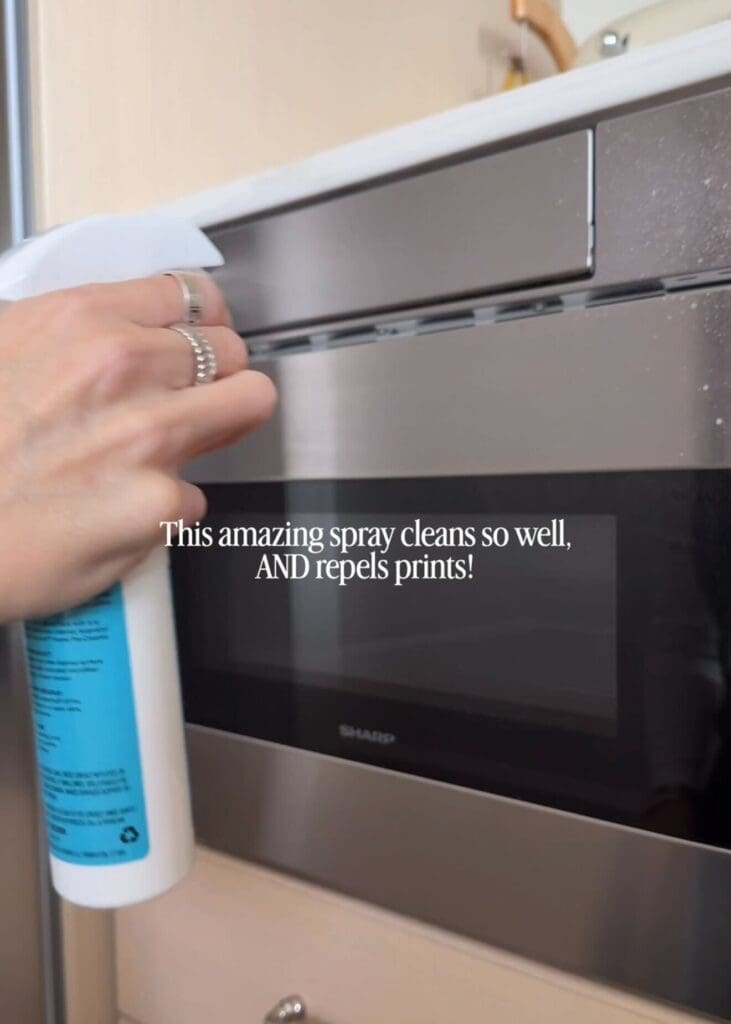 Cleaning spray being applied to stainless steel appliance.